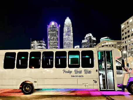 Prestige Party Bus with Charlotte Skyline at Night